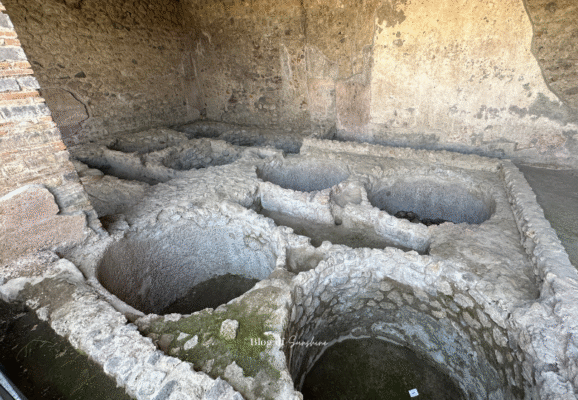 Multiple pilae (washing basins) in a fullonica in Pompeii, part of the ancient Roman textile and dyeing industry
