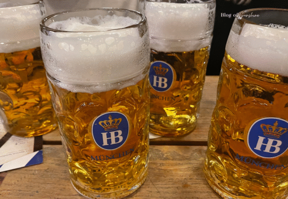 Traditional Bavarian beers served at Beer Pub München in Berlin, in large steins on a wooden beer hall table