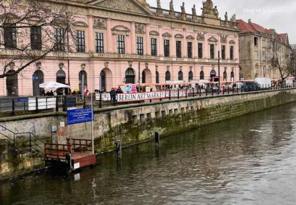 View of Berlin Art Market along the Spree River in front of the pink facade of the Altes Museum