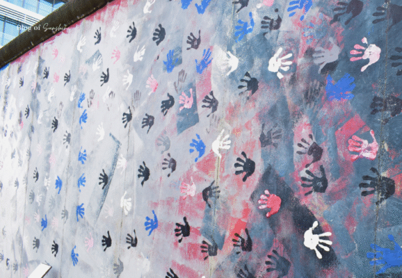 Colorful handprint mural symbolizing peace and unity at the East Side Gallery