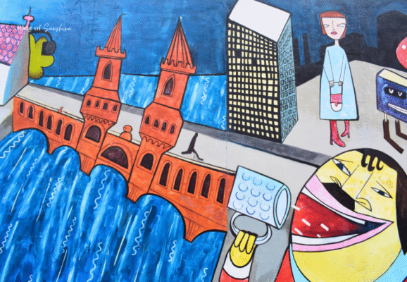 Cartoon mural of Berlin's Oberbaum Bridge with beer mug and city skyline