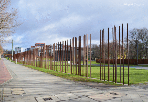 Row of rusted steel poles marking the former Berlin Wall path at Bernauer Straße Memorial in Berlin