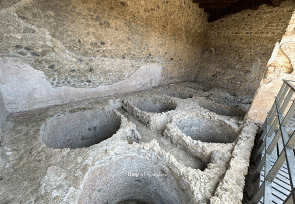 Large stone washing basins in the Fullonica of Stephanus, used for laundering clothes in ancient Pompeii