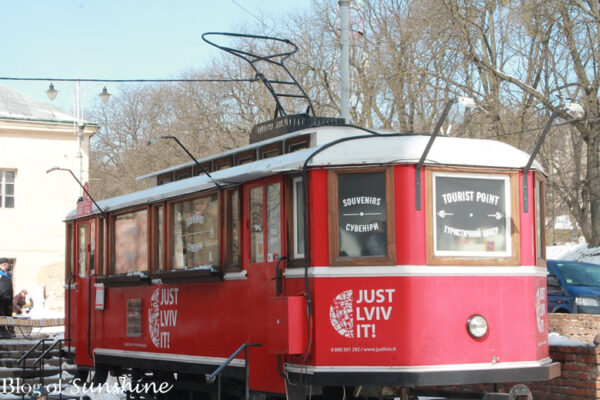 Bright red tram in Lviv converted into a tourist point and souvenir shop with 'Just Lviv It!' branding