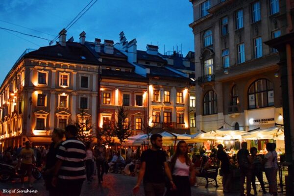 People enjoying a summer evening at the glowing cafés and restaurants of Rynok Square in Lviv, Ukraine