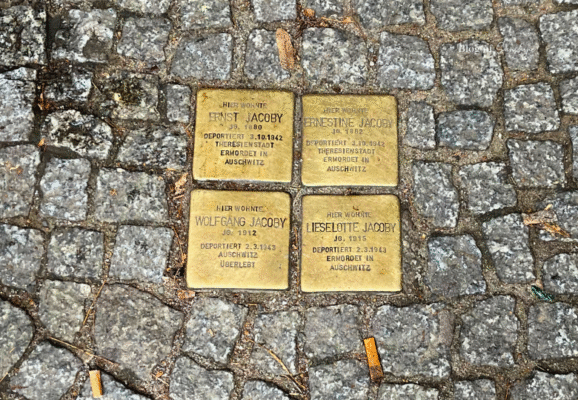 Stolpersteine for the Jacoby family in Berlin, showing deportation details and Auschwitz memorial stones