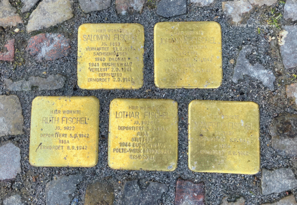 Stolpersteine memorial plaques for the Fischel family outside their former home in Berlin, commemorating Holocaust victims