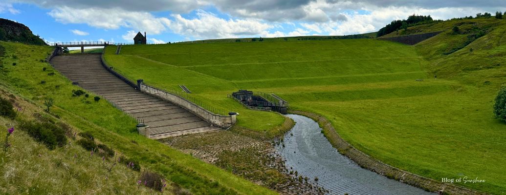 Butterley Reservoir in Marsden near Huddersfield with spillway and green hills, featured in Northern England day trips guide