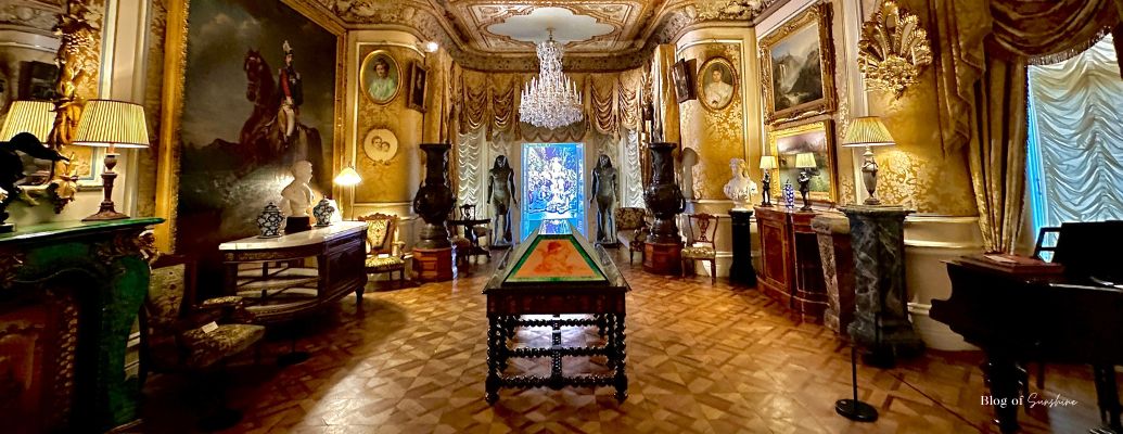 Interior of Cliffe Castle in Keighley, showing ornate golden room and chandeliers, featured in Northern England day trips guide