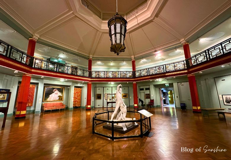 Circular main gallery room at Cliffe Castle Keighley with statue and red columns