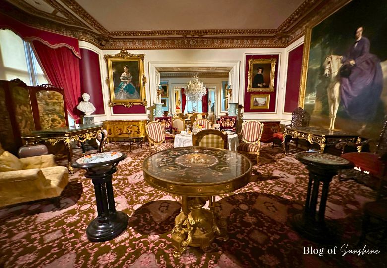Victorian sitting room with antique furniture and portraits at Cliffe Castle Keighley