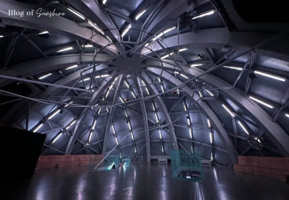 Futuristic blue and white lighting inside the dome of the Atomium sphere