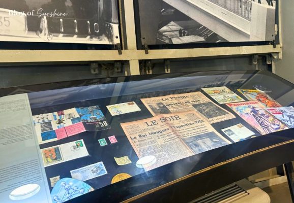 Glass case filled with original Expo 58 tickets, newspapers, and stamps