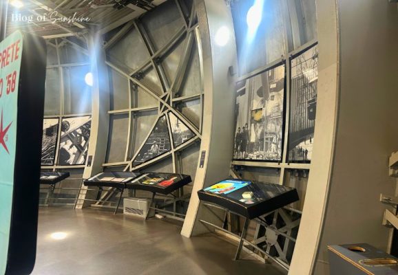 Interior of the first Atomium sphere featuring black-and-white photos and historical exhibits