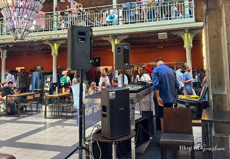 Live DJ playing inside Halles Saint-Géry during vintage market