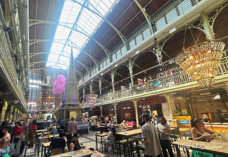 Inside Halles Saint-Géry vintage market with shoppers and DJs in Brussels