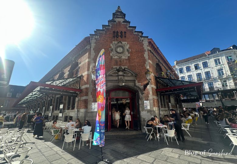 Exterior of Halles Saint-Géry in Brussels with outdoor café and market