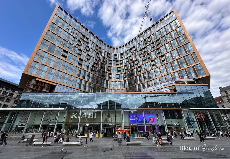 Modern curved glass building with shops at Place de la Monnaie Brussels