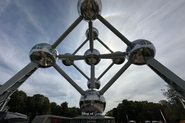 Upward view of the Atomium in Brussels with sun halo behind the steel spheres