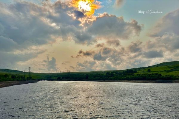 Sunset sky and rippling water on the Baitings Reservoir circular walk near Rishworth