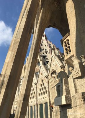 View through angled stone columns of the Passion Facade at the Sagrada Família