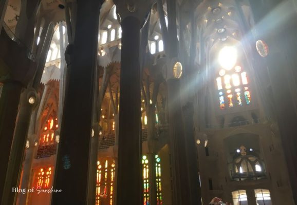 Afternoon sunlight shining through Passion Facade stained glass inside the Sagrada Família