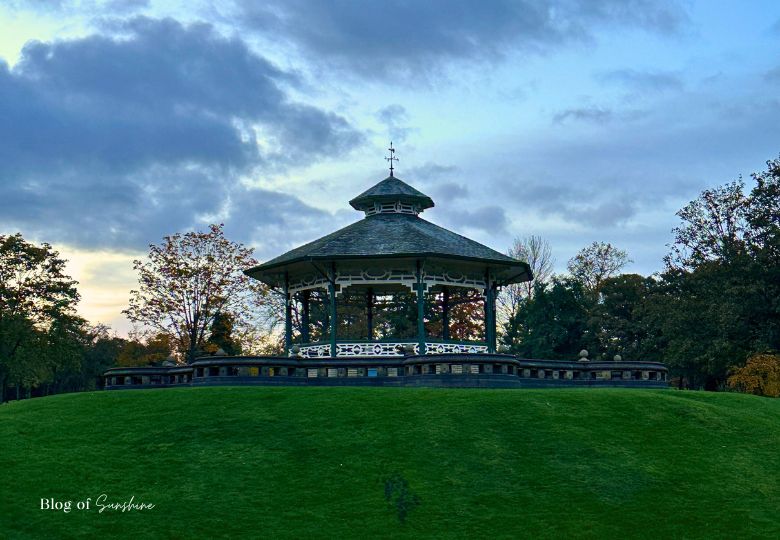 Victorian bandstand in Greenhead Park Huddersfield on a grassy hill at sunset