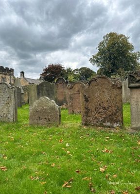 Row of old gravestones in the churchyard beside Hexham Abbey
