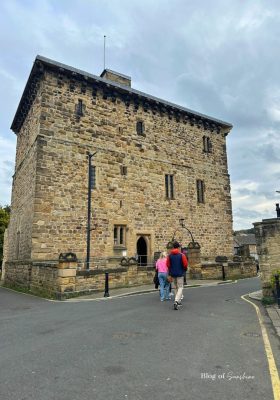 Visitors walking up to Hexham Old Gaol, medieval prison museum in Hexham town centre