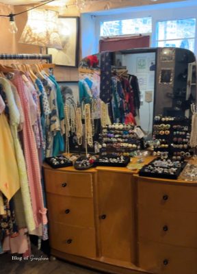 Vintage shop in Hexham with rails of dresses and a dresser covered in jewellery
