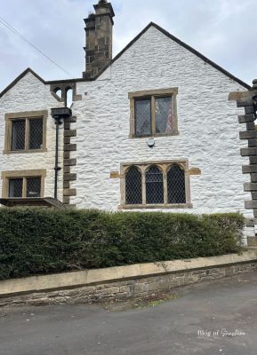 White stone cottage with mullioned windows on the walk from Wentworth Car Park into Hexham town centre