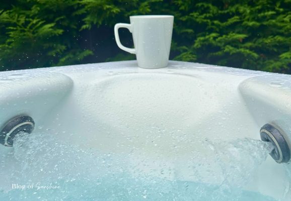Bubbling private outdoor hot tub at Seaham Hall Garden Suite with a mug on the edge