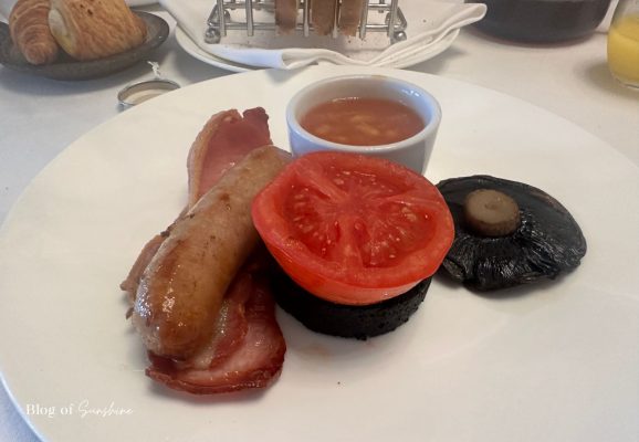 Full cooked breakfast served at Seaham Hall Hotel with sausage, bacon, tomato, black pudding, mushroom and baked beans