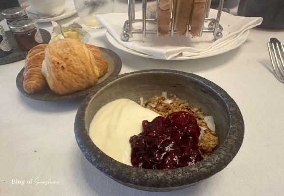 Granola with yoghurt and fruit compote with pastries served at Seaham Hall Hotel breakfast table service