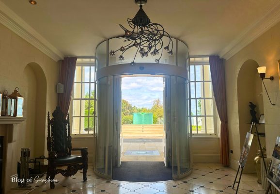 Seaham Hall Hotel entrance hall with revolving door and view of the fountain outside