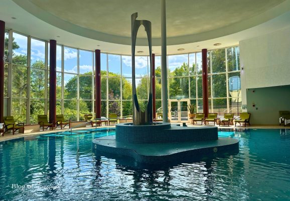 Main swimming pool at Serenity Spa, Seaham Hall Hotel with tall windows and relaxing loungers