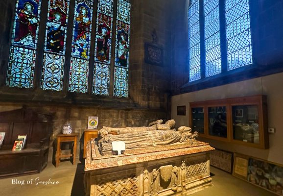 De Bower alabaster tomb beneath stained glass in St John the Baptist Church Tideswell near Buxton