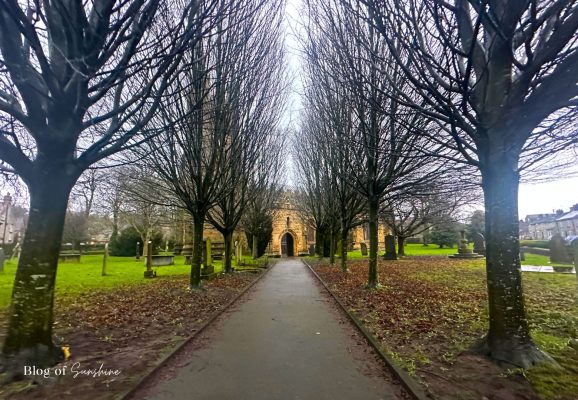 Tree-lined path leading to St John the Baptist Church Tideswell near Buxton