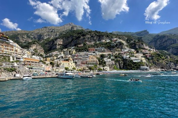 View of the Amalfi Coast from the water near Sorrento with colourful hillside buildings and boats