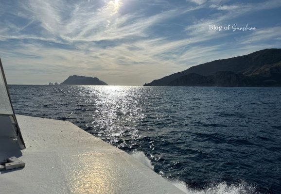 View from a ferry travelling from Sorrento to Amalfi with sparkling sea and Amalfi Coast cliffs