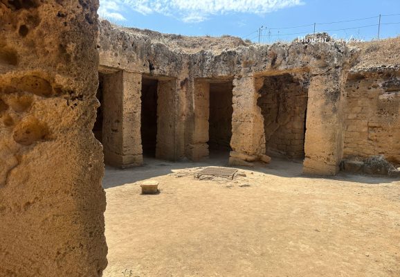 Rock-cut courtyard with stone columns at Tombs of the Kings in Paphos Cyprus