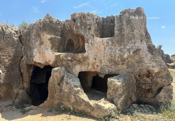 Rock-cut tomb wall with openings at Tombs of the Kings in Paphos Cyprus